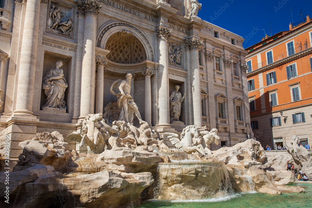 Tourists at the Trevi Fountain designed by Italian architect Nicola Salvi and completed by Giuseppe Pannini  in 1762