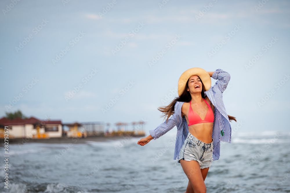 Beautiful woman on the beach during summer vacation Beautiful woman on the beach during summer vacation