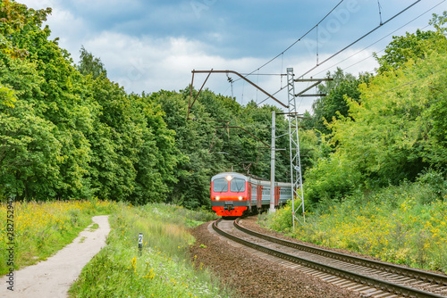Passenger train moves through countryside, Moscow region. Russia.