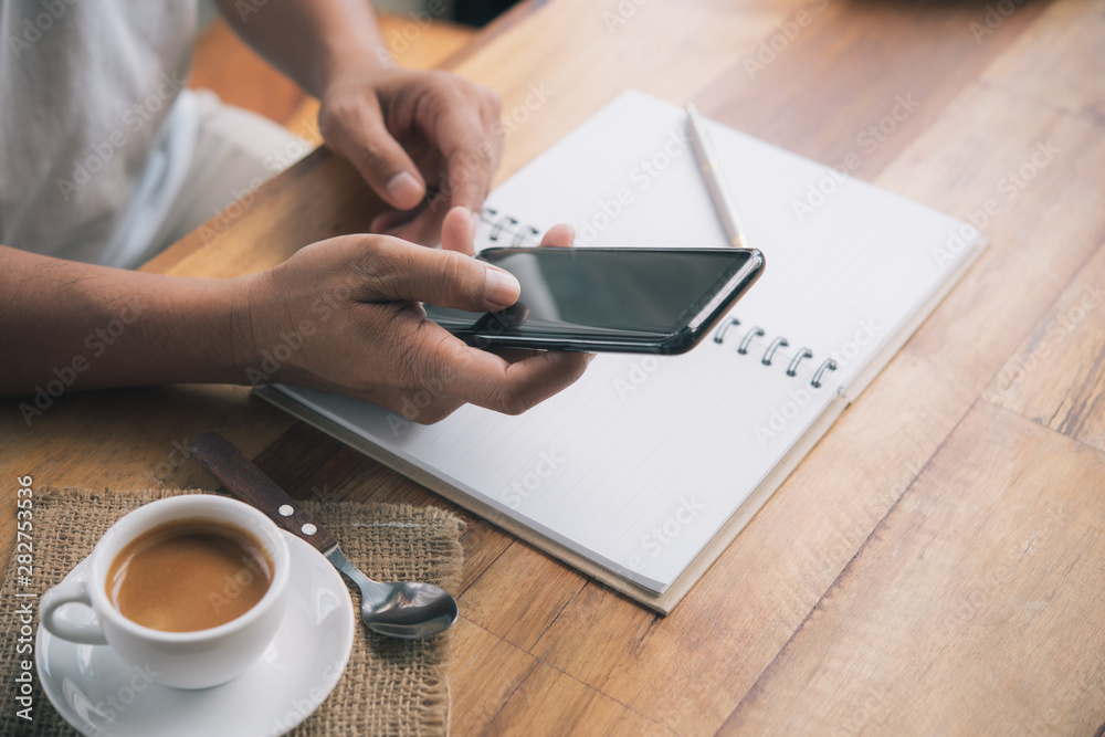 Men's hands are using a smartphone at home. Men's hands are using a smartphone at home.