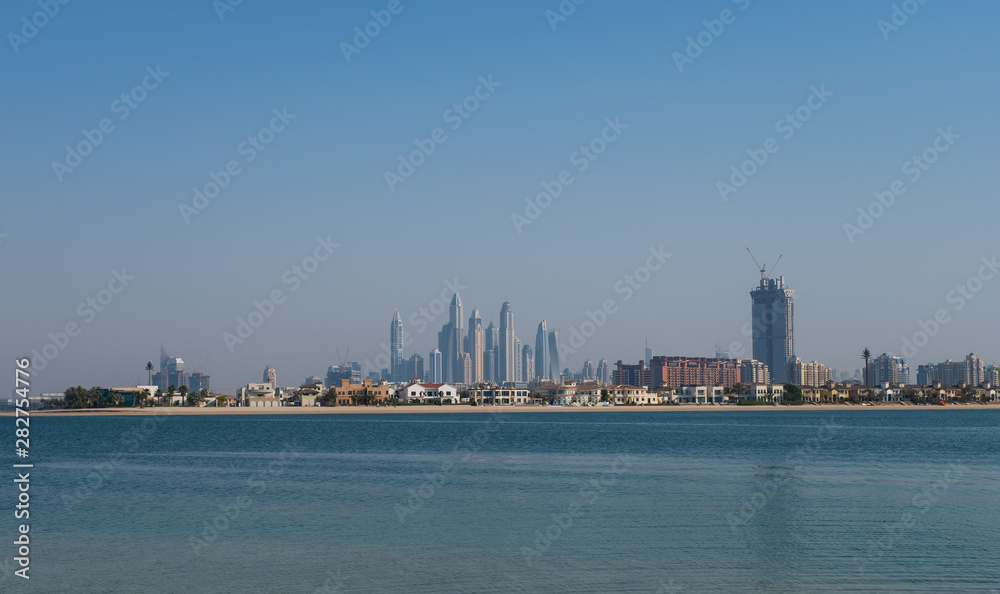 DUBAI, UAE - may 2019. View of various skyscrapers including Cayan Tower in Dubai Marina with stunning turquoise waters as foreground