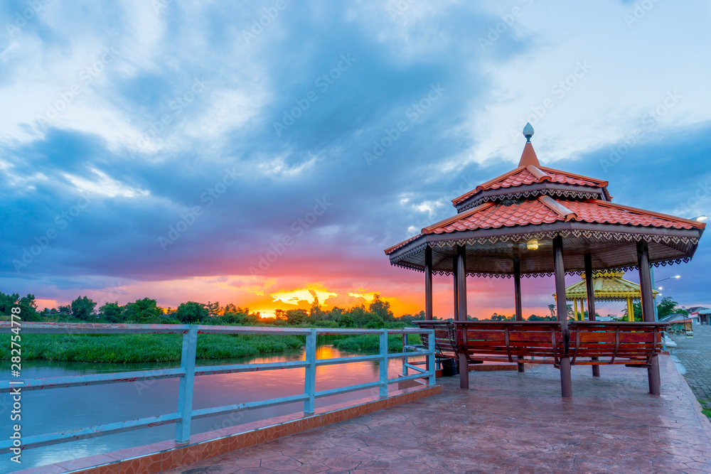 the beautiful .pavilion near the river with the beautiful sunset on the evening the beautiful .pavilion near the river with the beautiful sunset on the evening