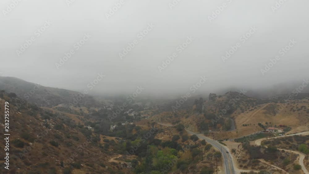 Aerial drone shot panorama of heavy cloud cover over a valley landscape Aerial drone shot panorama of heavy cloud cover over a valley landscape