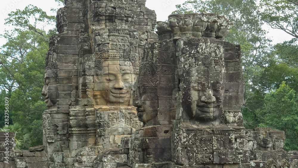 four large carved stone faces at bayon temple
