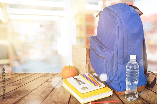 School Backpack with stationery on background photo