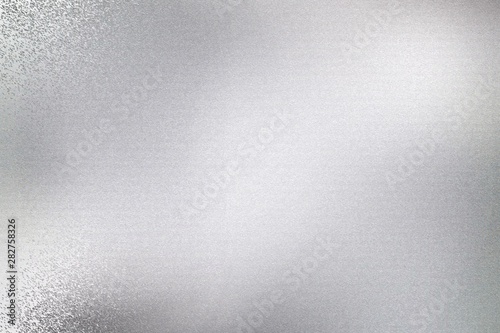 Silver metal sheet with scratched surface, abstract texture background