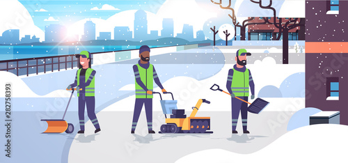cleaners team using different equipment and tools snow removal concept mix race men women in uniform cleaning urban residential area cityscape background flat full length horizontal
