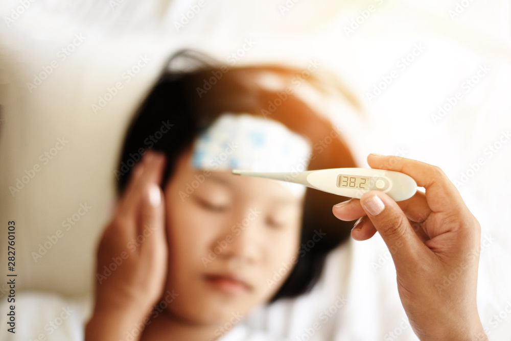 fever child with thermometer measuring temperature of kid sick child