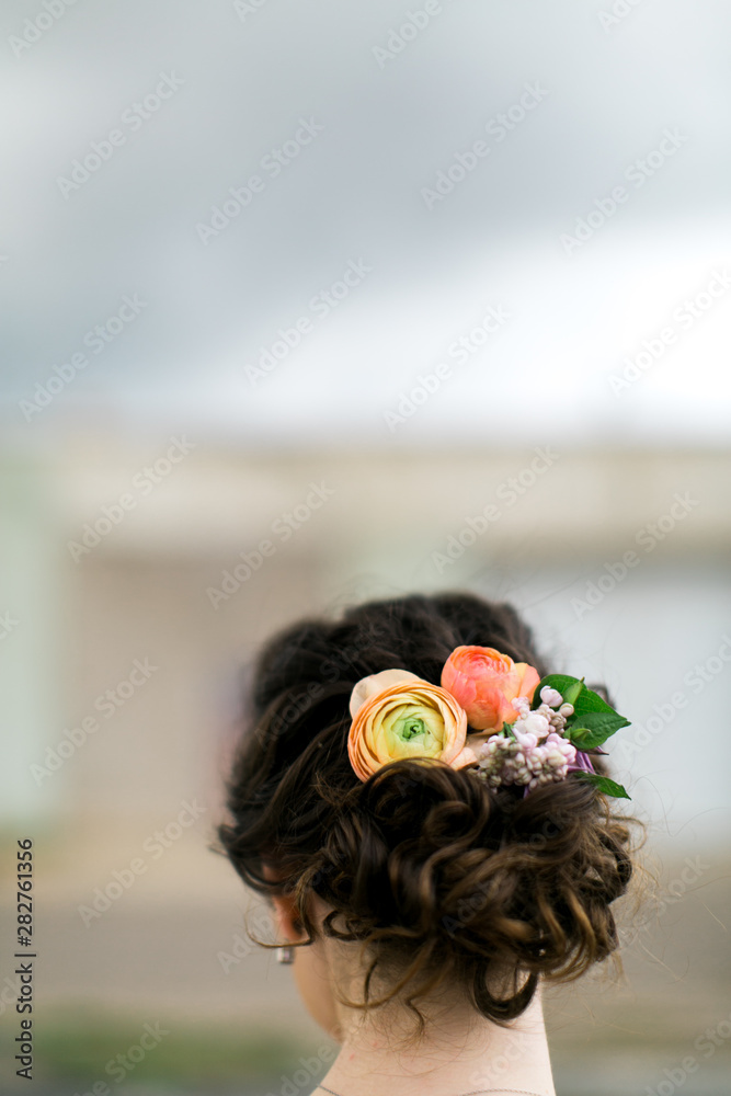 Modern Bridal Updo Hairstyle with fresh flowers, braided wedding hair, bride's  wedding day bun Stock Photo | Adobe Stock