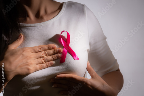 Wallpaper Mural Closeup of pink badge ribbon on woman chest to support breast cancer cause. Healthcare, medicine and breast cancer awareness concept. Torontodigital.ca