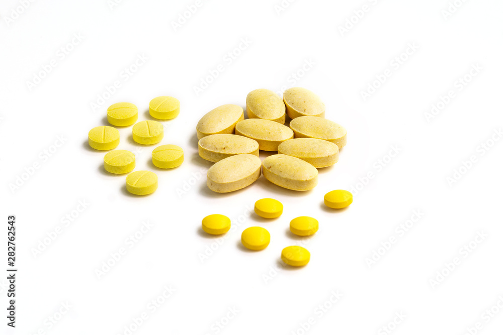 Close up assorted medical drugs, antibiotic pharmaceutical medicine pills and syringe isolated on white background. Yellow tablets pills with copy space. Medicine and healthy concept. Close up assorted medical drugs, antibiotic pharmaceutical medicine pills and syringe isolated on white background. Yellow tablets pills with copy space. Medicine and healthy concept.