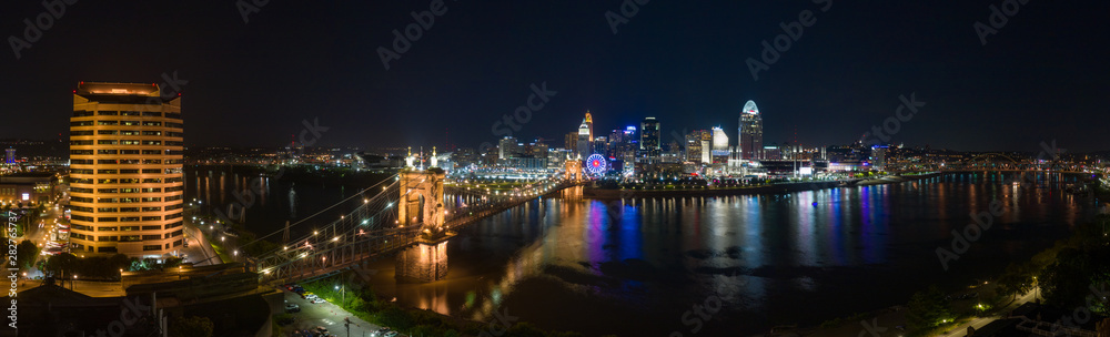 Aerial night view of the Roebling bridge over the Ohio river and Downtown Cincinnati during the summer