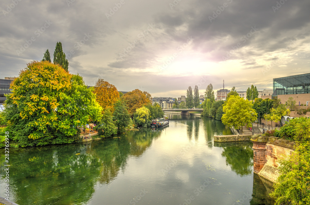 Cityscape of Strasbourg at sunset and Ill river in october, France