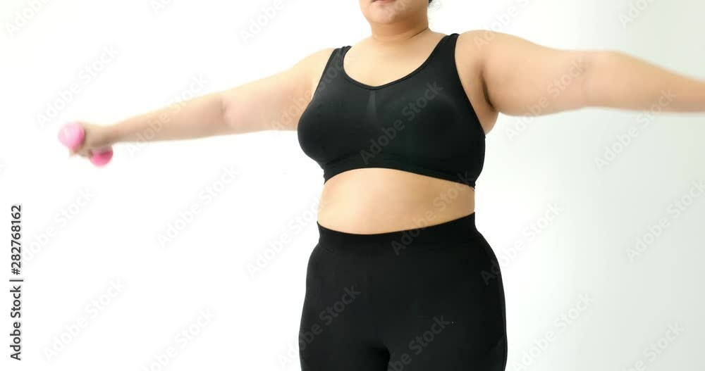 Overweight young woman in sportswear exercising to lose weight at home Overweight young woman in sportswear exercising to lose weight at home
