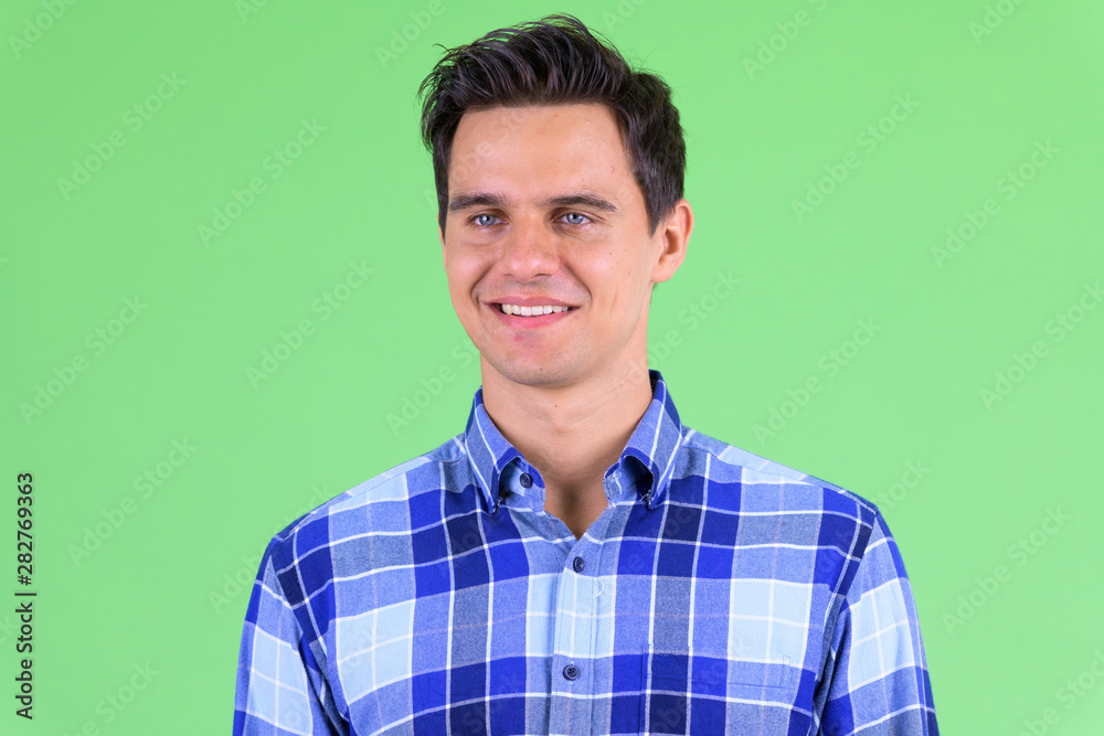 Face of happy young handsome hipster man thinking Face of happy young handsome hipster man thinking