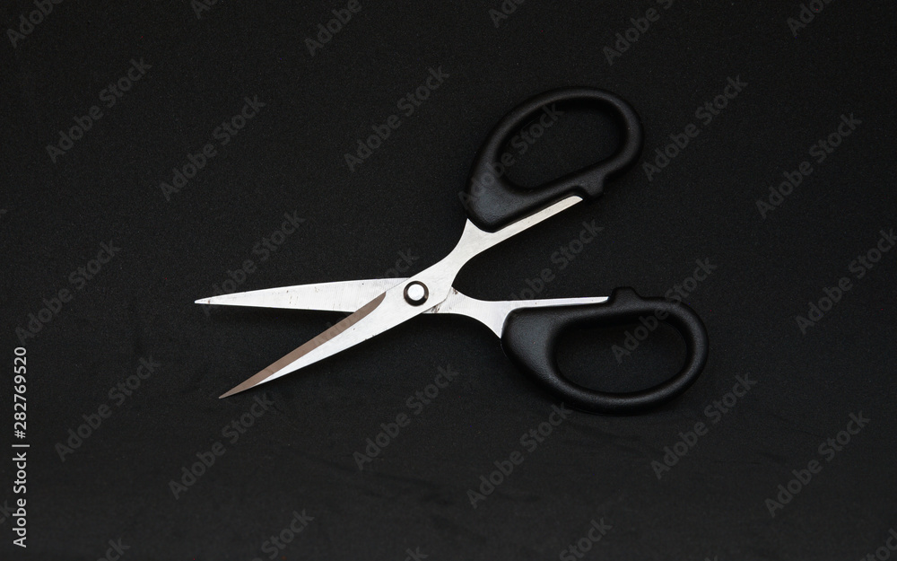 Black scissor in black background Black scissor in black background