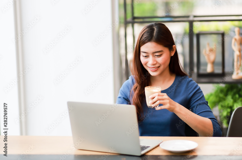 Asian business girl working and drinking coffee in cafe Asian business girl working and drinking coffee in cafe