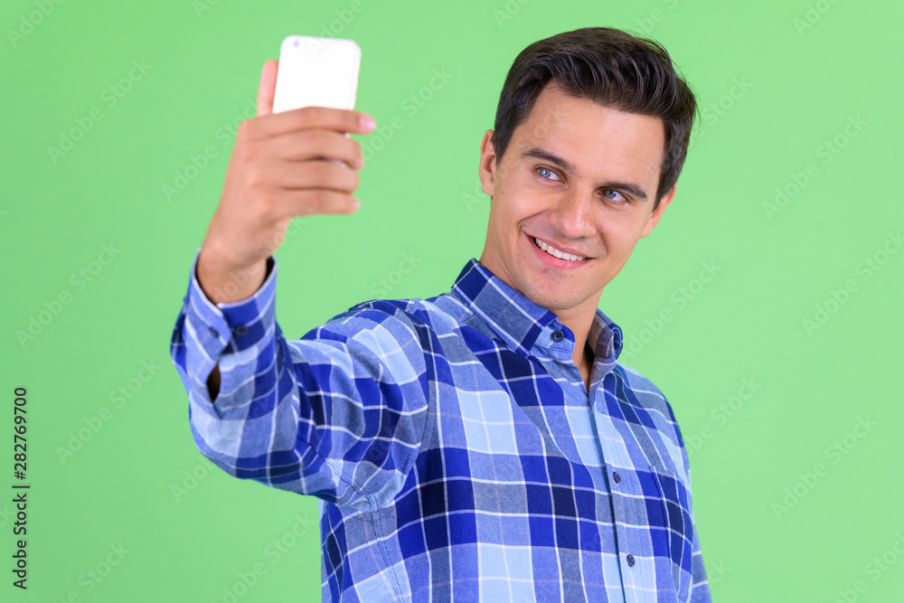 Happy young handsome hipster man taking selfie Happy young handsome hipster man taking selfie