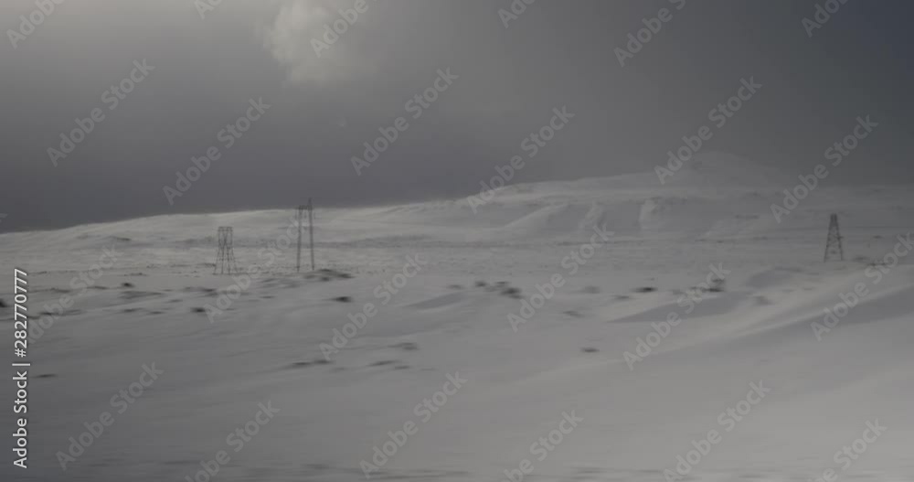 The snowy Icelandic countryside dotted with power transformers.