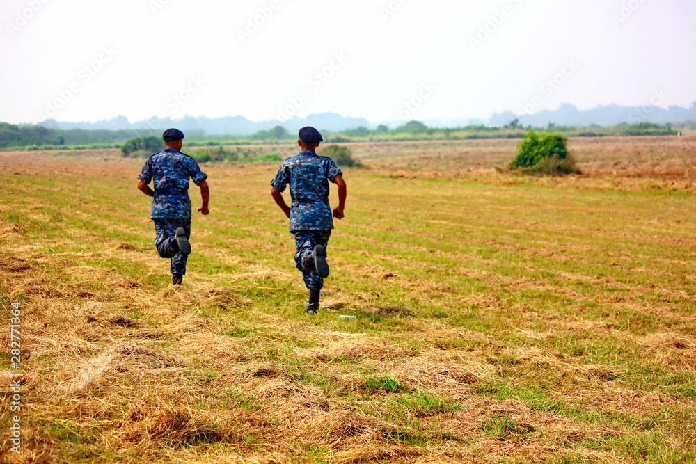 two soldiers in uniform running to the goal. two soldiers in uniform running to the goal.