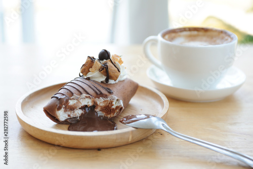 Relax time with Chololate lava cake and cappucino coffee on wooden table, coffee time