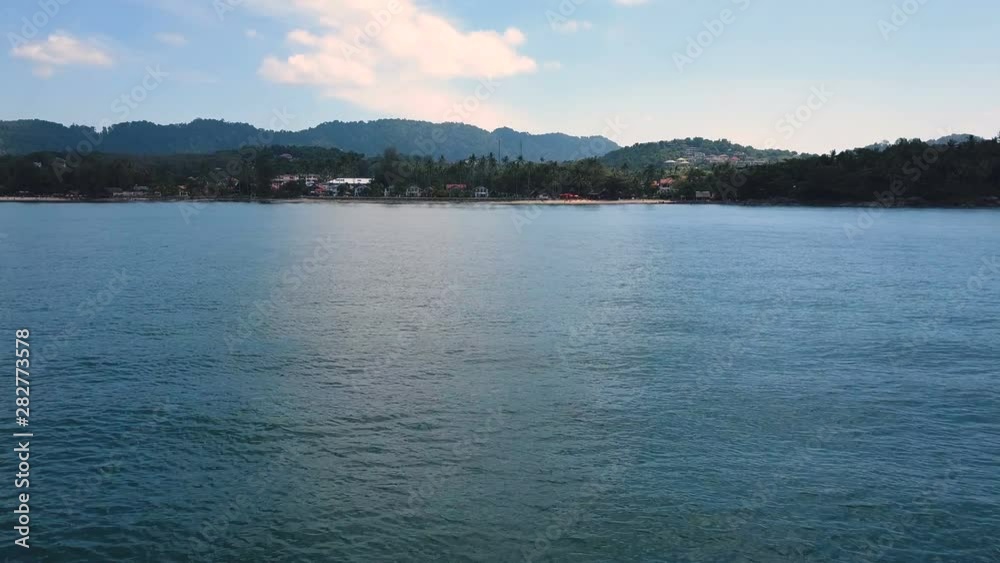 Flying near sea water to coastline on Phuket island in Thailand Flying near sea water to coastline on Phuket island in Thailand