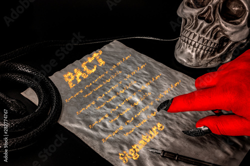 Фотография Pact or deal with the devil, faustian bargain and selling one's soul to Satan co