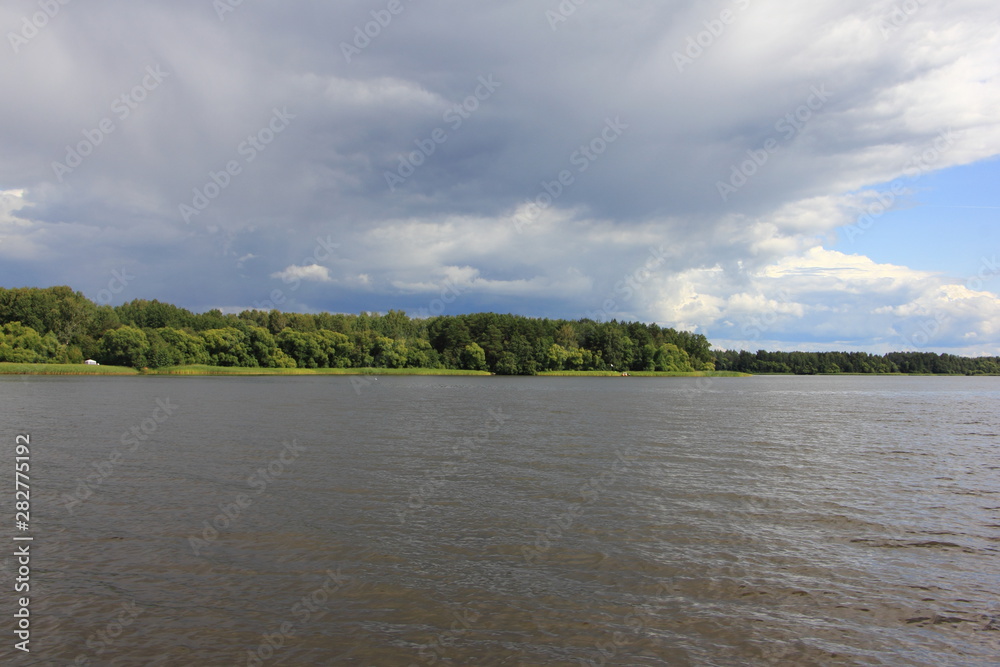 Storm clouds over the water, beautiful river landscape on a summer day