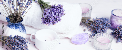 Spa massage setting, lavender product, salt, candles, soap on white background