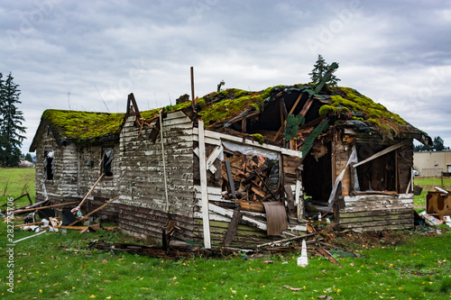 Ruins of abandoned house on cold fall day before final demolition.