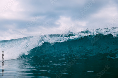 Breaking blue wave. Barrel wave for surfing.