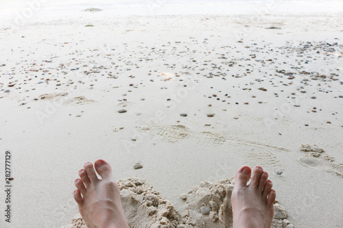 barefoot relaxing in the sand