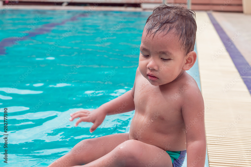  asian children having fun in a swimming pool at thailand