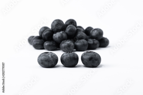 Big, sweet black blueberries on a white background