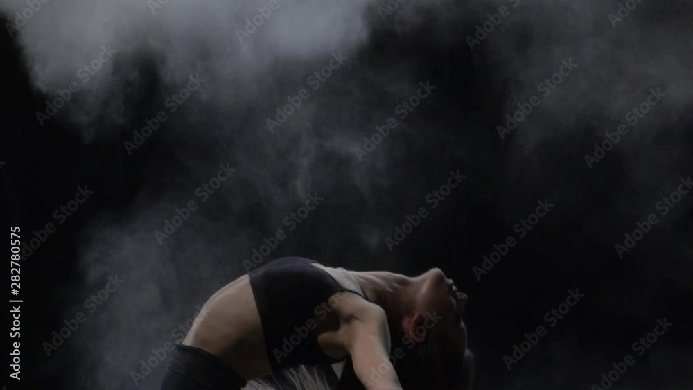 Closeup slow motion, virtuoso dancer throwing dust particles in air