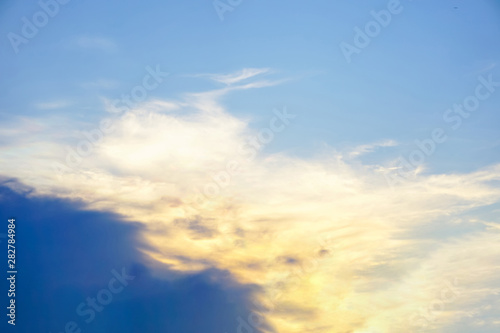 Blue sky and black clouds with reflective sunlight from the sun ,nature background in evening day