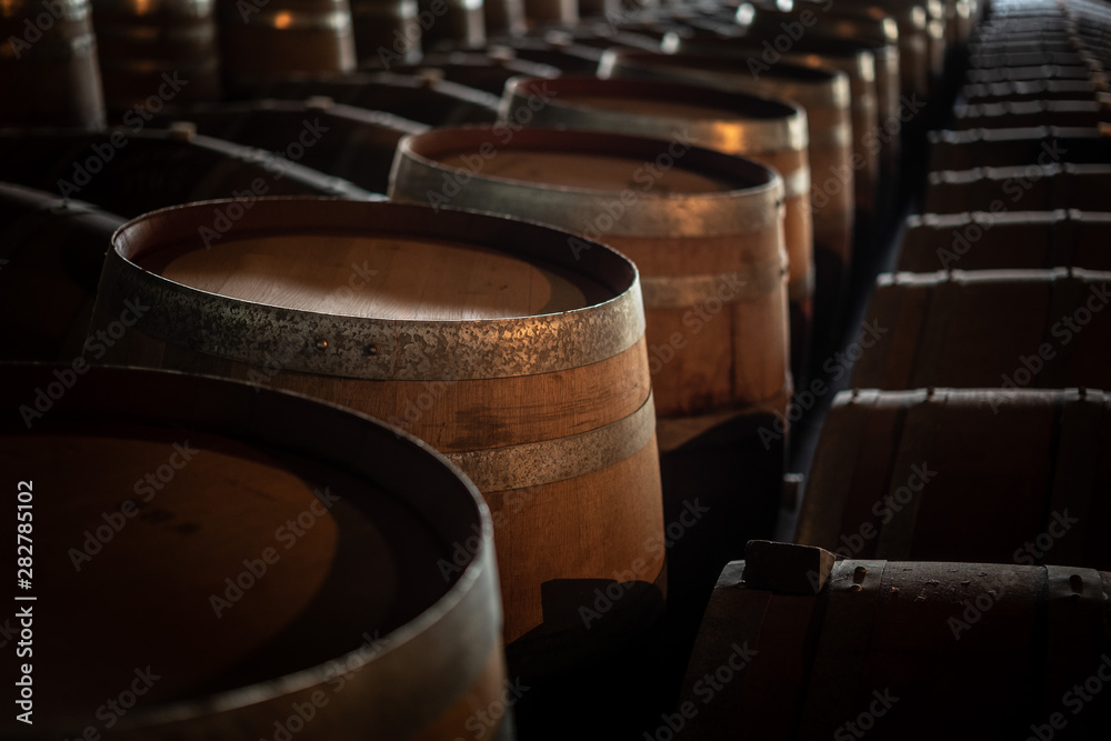 Obraz premium old barrels of wine in a cellar