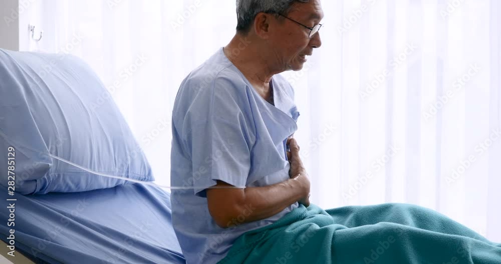 Elderly patient having having heart attack on hospital bed Elderly patient having having heart attack on hospital bed
