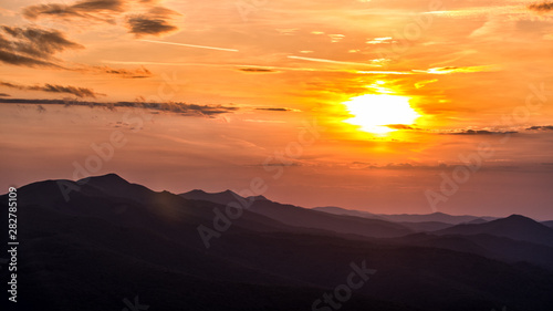 Stunning sunset in the mountains. Orange sky and mountains silhouettes. Carpathian Mountains. Bieszczady. Poland © Szymon Bartosz