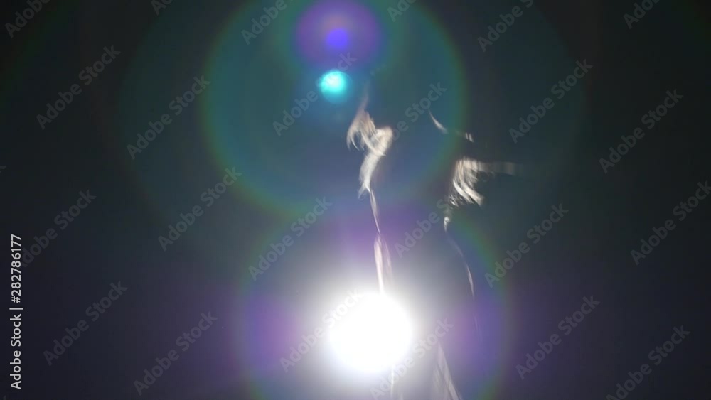 Slow motion performer practicing contemp in dark studio. Close-up