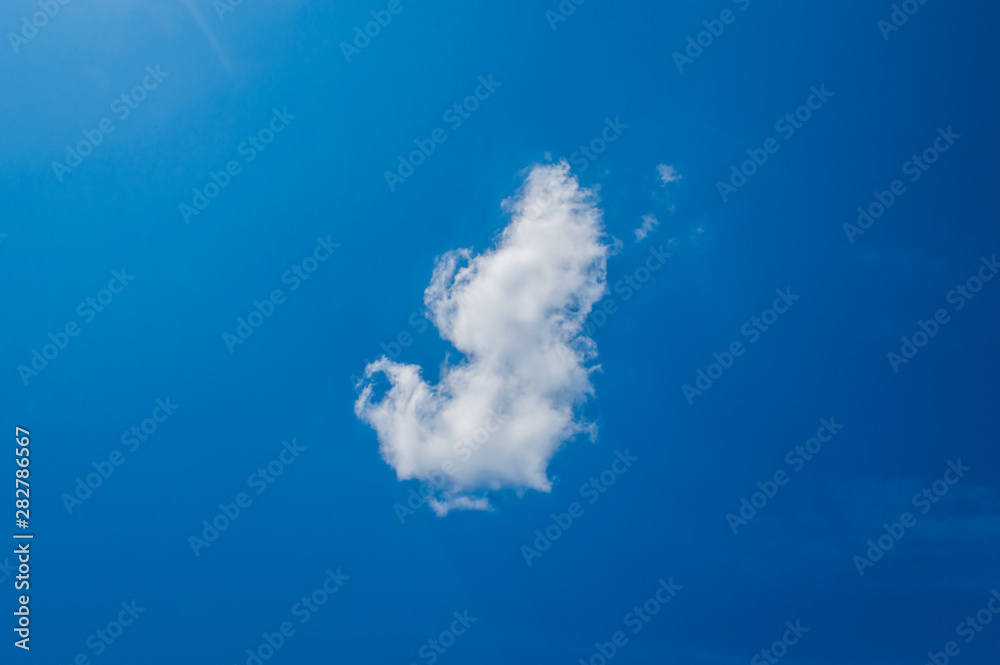 One cumulus cloud on a blue sky One cumulus cloud on a blue sky