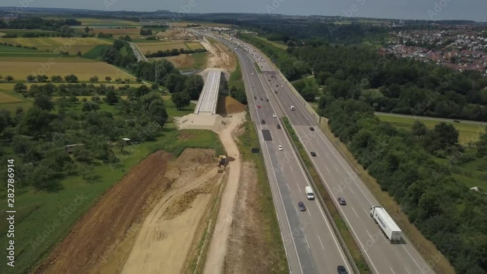 Aerial view of a German Autobahn with construction works for a new railway track next to it. Drone footage taken at Denkendorf near Stuttgart - on a weekend, hence not much truck traffic. Aerial view of a German Autobahn with construction works for a new railway track next to it. Drone footage taken at Denkendorf near Stuttgart - on a weekend, hence not much truck traffic.