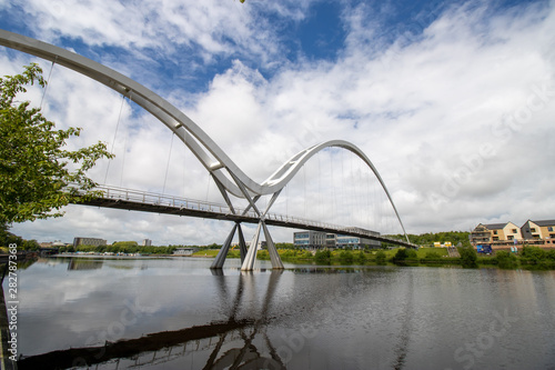 Photo of The famous Infinity Bridge located in Stockton-on-Tees taken on a bright sunny part cloudy day. photo