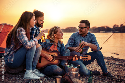 Friends enjoying music on the beach