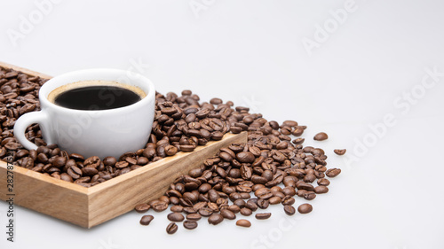 cup of coffee and beans on white background with text space