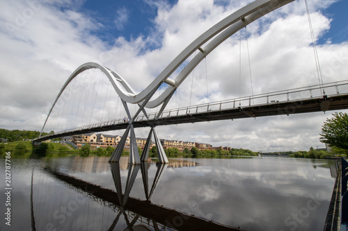 The famous Infinity Bridge located in Stockton-on-Tees taken on a bright sunny part cloudy day. photo