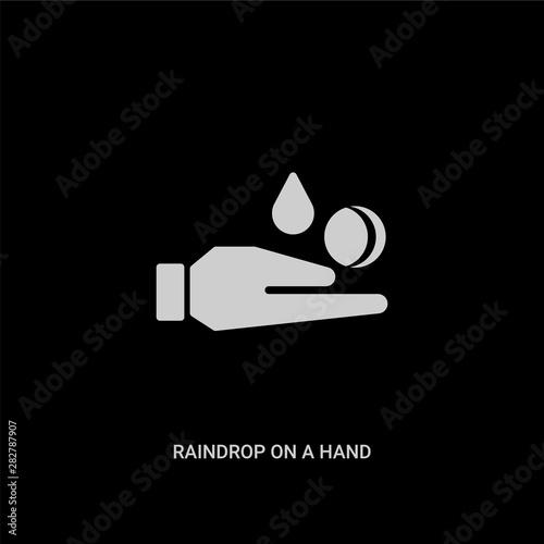 white raindrop on a hand vector icon on black background. modern flat raindrop on a hand from ecology concept vector sign symbol can be use for web, mobile and logo.