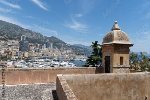 View from the top of mountain, in background is Port of Monaco, big ships and houses. Amazing landscape, blue sky and sea. Summer time.