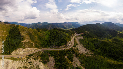 A landscape view of beautiful fresh green forest, road Chui tract and Altai mountain background. Panoramic view of beautiful green forest in the Altai mountains