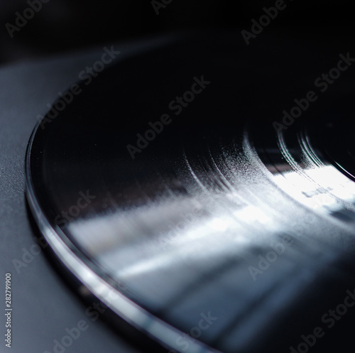 clean new black vinyl record grooves with reflection texture close up view